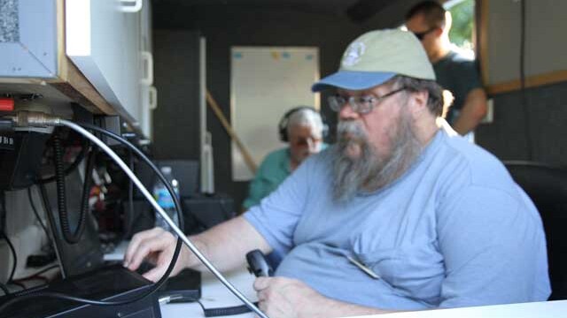 Tom, KJ4FUU in the club trailer working some good DX Field-Day-2012-KJ4FUU